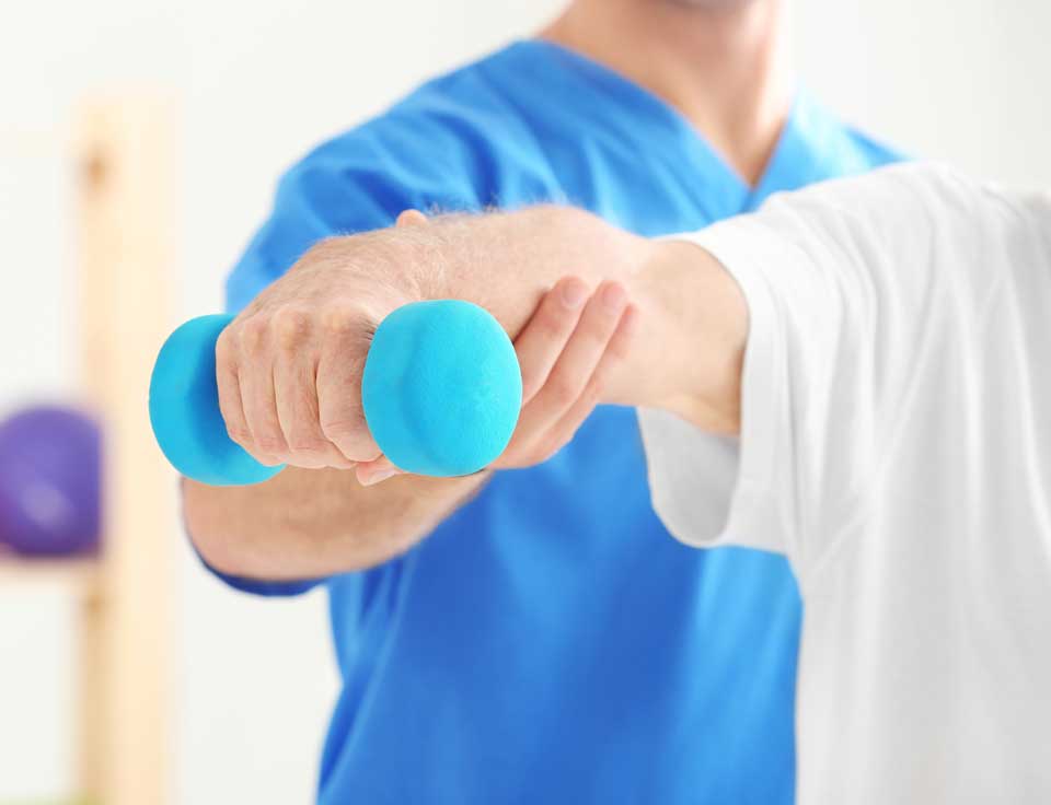 Beverly Hills & Spring Hill, FL Sports Injury Chiropractor a chiropractor is treating a patient unto his arms