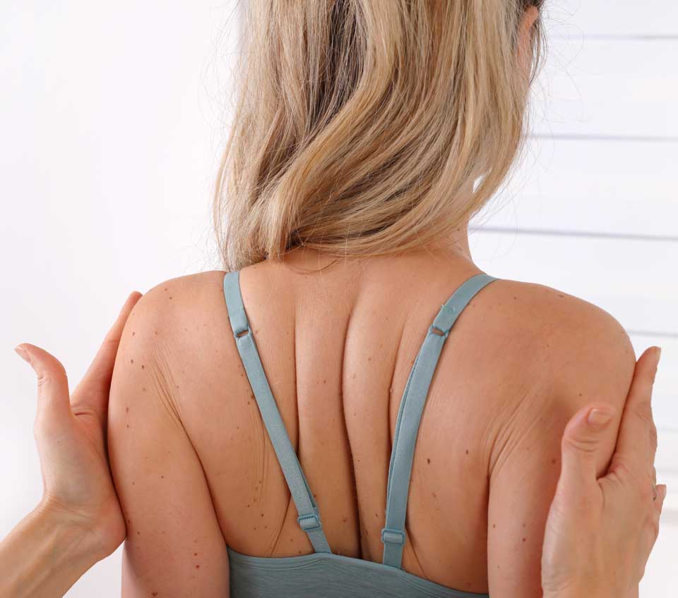 Beverly Hills & Spring Hill, FL Chiropractic Back Pain Relief a woman is being treated by a chiropractor due to her back pain